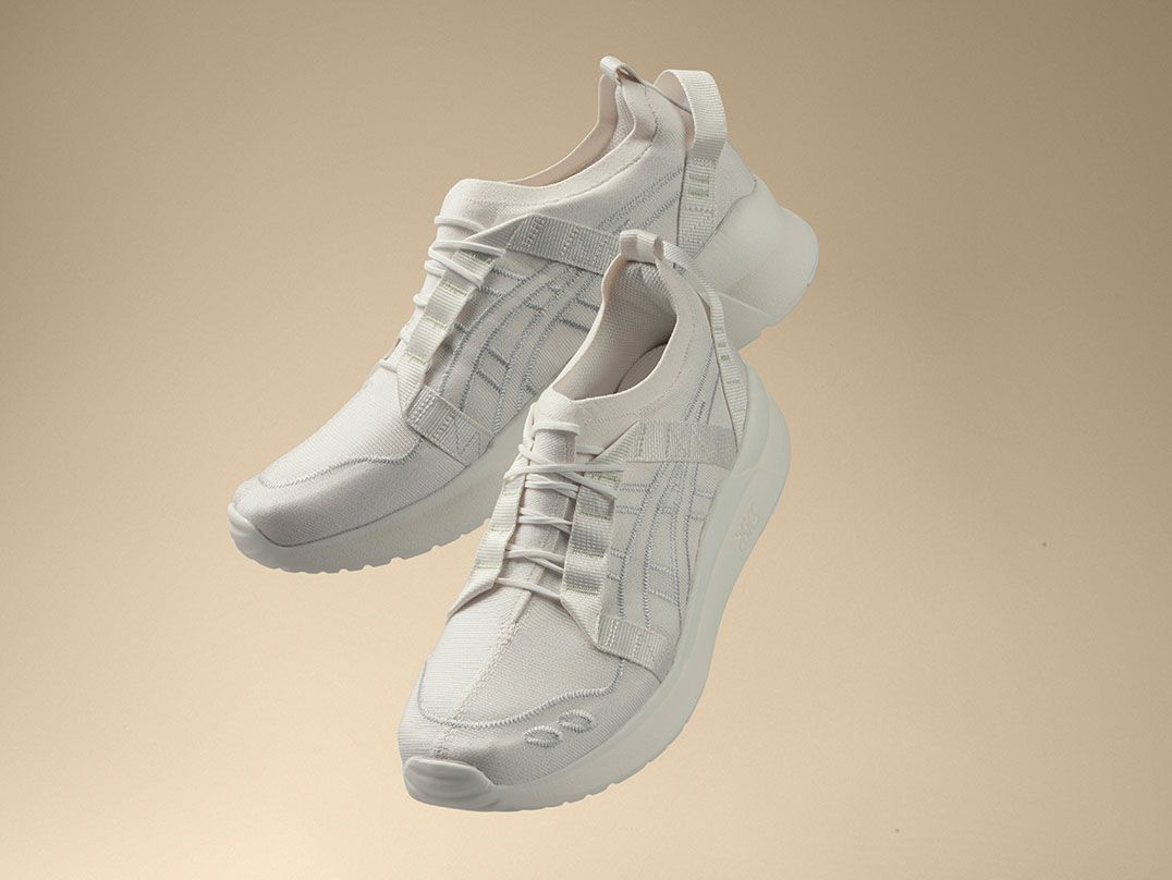 The all-white GEL-LYTE™ III CM 1.95 shoe floats mid-air amidst a beige background